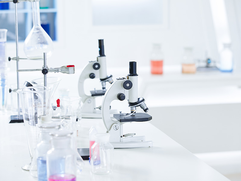 Microscopes and laboratory glassware used for fragrance material testing at Linxingpinechem.